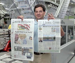 Lafayette Journal-Courier President Gary Suisman compares the new \'Berliner" size newspaper, right, with the standard size newspaper, Sunday, July 30, 2006 in Lafayette, Ind. With Monday\'s edition, the Journal-Courier becomes the first newspaper in North America to adopt the \'Berliner\' size newspaper which falls between the common size newspaper and a tabloid. (AP Photo/John Harrell)