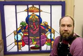 Tim Clougher with "Ganesha", a glass work. David Snodgress | Herald-Times