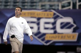 Florida coach Urban Myer walks on the field at the Georgia Dome before his team\'s practice Friday. Florida will face Arkansas in the SEC Championship game today. John Bazemore | Associated Press