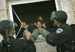 A Jewish settler is pulled out of a building by Israeli police as authorities evacuate the West Bank settlement outpost of Amona, east of the Palestinian town of Ramallah, on Wednesday. Emilio Morenatti | Associated Press