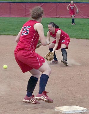 BEDFORD — BNL’s Chelsea Calentine fields the ball as Sara Greer covers first base Thursday against Orleans. (Times-Mail / PETE SCHREINER).