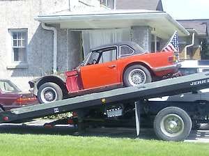 BEDFORD — The 1973 Triumph TR6 that Deb Cory traded for a 1999 Land Rover is loaded onto a trailer. The new owners, friends of Cory, are looking forward to restoring the British-made sports car.