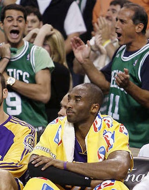 The Lakers’ Kobe Bryant sits on the bench as fans in Boston cheer during the Celtics’ 108-102 win in Game 2 of the NBA finals in Boston Sunday. The Lakers return to Los Angeles for Game 3 tonight down 2-0 in the best-of-seven series.Winslow Townson | Associated Press
