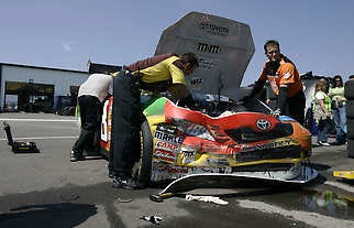 Crew members work on the damaged car of Kyle Busch in the garage area following a crash during Saturday morning’s practice for today’s Pocono 500 at Pocono Raceway in Long Pond, Pa.Carolyn Kaster | Associated Press