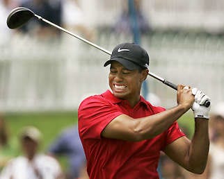 Tiger Woods grimaces after teeing off on the second hole during the fourth round of the U.S. Open last Sunday at Torrey Pines Golf Course in San Diego. Woods, who won the tournament in sudden death following a playoff on Monday, will miss the rest of the season because of surgery on his left knee.Charlie Riedel | Associated Press