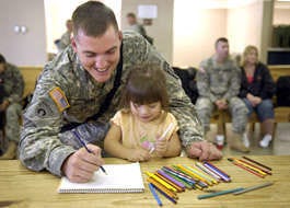 Staff Sgt. Matt McCaslin, 659th Maintenance Company, draws Wednesday with his 2-year-old daughter, Naomi, at Pope Air Force Base in North Carolina, as friends and families gather to see off their loved ones before their deployment to Iraq. Stephanie Bruce | Associated Press