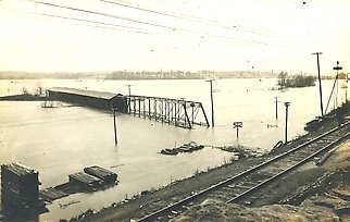 A covered bridge and a steel bridge leading up to it in Gosport are both still submerged by floodwaters on April 5, 1913, after heavy rains deluged the Midwest March 23-27, 1913. This photo is from the Jay Small Postcard Collection at the Indiana Historical Society. Indiana Historical Society, P0391 | courtesy to H-T