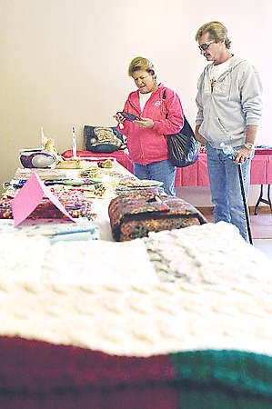 BEDFORD — Gini and Ron Cole check out items for sale at the Grace Full Gospel Church Holiday Bazaar and Bake Sale.