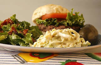 A summertime grilled hamburger is made even better with the addition of some summer salads, Mango-Jalapeno Coleslaw and Wilted Lettuce. Jeremy Hogan | Herald-Times