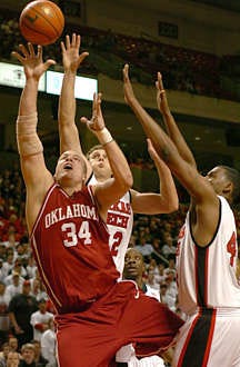 Oklahoma\'s Kevin Bookout (34) shoots against Texas Tech\'s Jon Plefka (32) and Darryl Dora (44) in the first half of the Sooners\' 71-70 win over the Red Raiders at the United Spirit Arena in Lubbock, Texas, Monday. Joe Don Buckner | Associated Press