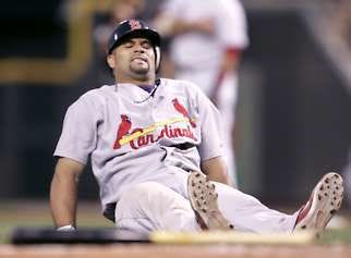 St. Louis’ Albert Pujols lies on the ground after injuring his left leg in the seventh inning of Tuesday’s game against Cincinnati. Al Behrman | Associated Press