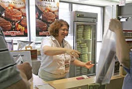 Robbi Pozzi sells steaks at the Omaha Steaks counter at Eppley Airfield in Omaha, Neb. Omaha Steaks has been selling steaks at the city\'s Eppley Airfield since the late 1970s. Nati Harnik | Associated Press