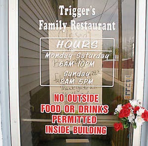 Flowers adorn the door of TriggerÕs Family Restaurant in Morgantown, which closed Tuesday. One of the owners said the sluggish economy and high gas prices are to blame. Photo by Aaron Blevins.
