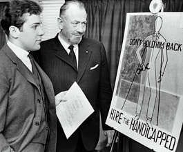 Nobel prize-winning author John Steinbeck, center, admires a poster created by his son, Thomas, in this file photo of March 22, 1963, in Hartford, Conn. Now 61, the younger Steinbeck is finding his own voice as an author. File photo | Associated Press
