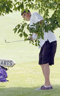 Souths Chad Sutor hits his second shot from under a tree on No. 14 during the first round of the boys state golf tournament Tuesday at The Legends of Indiana in Franklin. Sutor shot 74 to lead the Panthers, who advanced to todays final round with a 306. Chris Howell | Herald-Times