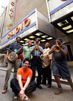 Members of the New Orleans Preservation Hall Jazz Band gather in front of Radio City Music Hall in New York Sept. 19, the day before they were to participate in the "From the Big Apple to the Big Easy" fundraiser. Standing, from left, are Carl LeBlanc, banjo; Benjamin Jaffe, bass; John Brunious, trumpet and vocals; Joe Lastie, drums; Lester Caliste; trombone and seated, Clint Maedgen, vocals. Mary Altaffer | Associated Press