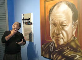 Cheech Marin with a portrait of himself at an exhibit in St. Louis in 2021. Most of the pieces in the exhibit were from Marin's personal collection.