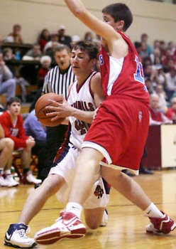 Bloomfield’s Byron Royal (40) has his path to the basket blocked by Owen Valley defender Adam Figg (12) during the Cardinals’ 53-26 loss to the Patriots Friday night.Jeremy Hogan | Herald-Times