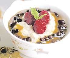 Rice Pudding is garnished with Cider and Raisin Sauce and fruit. With its creamy custard and distinctive texture, rice pudding is good and simple cooking, and a perennial favorite. This version is made with a recipe from the Culinary Institute of America\'s "Gourmet Meals in Minutes" cookbook. AP photo