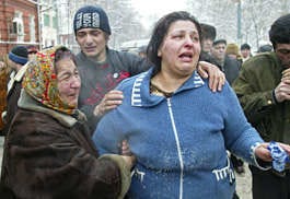 Relatives of victims cry Thursday near the wreckage of a market that collapsed in Moscow.Alexei Sazonov | Associated Press