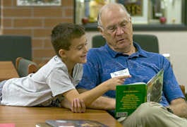 Bill Stuebe helps Summit Elementary student Nick Farber develop his reading skills. Stuebe works through RSVP, Retired Senior Volunteer Program, that pairs volunteers with individual students. David Snodgress | Herald-Times
