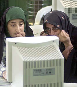 Two women work at a computer in the village of Qarn Abad, 240 miles northeast of Tehran in this file photo. Hasan Sarbakhshian | Associated Press