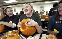 Hannah Sobkoviak, a vault teller with Monroe Bank, volunteered her time carving pumpkins at Pinnacle School Wednesday afternoon in association with the United Way\'s Day of Caring. Sobkoviak was polling the other volunteers on what to carve on her next pumpkin.