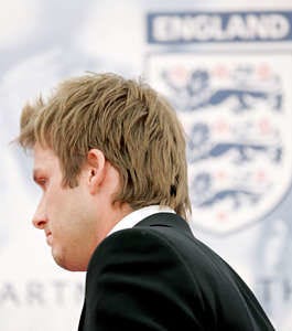 David Beckham walks away after reading a statement announcing his resignation as captain of the England national soccer team at Mittelbergstadion in Buehlertal, Germany, Sunday. A tearful Beckham read the statement in front of a crowded news conference in England\'s training camp, stressing that he wanted to continue playing for England.Matt Dunham | Associated Press