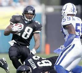 Jacksonville’s Fred Taylor runs around the block of teammate Brad Meester as the Colts’ Cato June closes in during Sunday’s game in Jacksonville, Fla. Taylor ran for 131 yards in the Jaguars’ 44-17 win over Indianapolis. Phil Coale | Associated Press