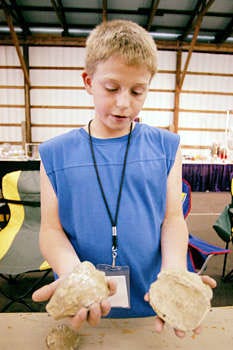 Skyler Sitterding talks about his hollow geodes and what might be in them at the Lawrence County Gem, Mineral, and Fossil Show Friday at the Monroe County Fairgrounds. Monty Howell | Herald-Times