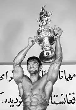 Aziz Ahmad Nakyar proudly shows off his trophy after he was chosen Mister Afghanistan at a national body-building competition Tuesday in Kabul, Afghanistan. Musadeq Sadeq | Associated Press