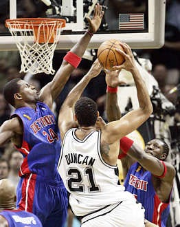 San Antonios Tim Duncan goes to the basket against Detroits Antonio McDyess (left) and Ben Wallace (right) during the third quarter of the Spurs 81-74 win in Game 7 of the NBA finals in San Antonio Thursday. Duncan was named the series MVP.Eric Gay | Associated Press