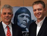 German brothers Dyrk, left, and David Hesshaimer pose in front a photo of the man they say is their father, pilot Charles A. Lindbergh. rkus Schreiber | Associated Press