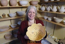 Jan Arbogast holds her work titled "Lotus Petal Colander" at her studio in Monroe County. Chris Howell | Herald-Times