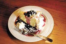 A blueberry sauce and fresh whipped cream top Lennie\'s cheesecake, one of the recipes that will be included in the Monroe County Historical Society\'s soon-to-be-out cookbook of local recipes. Staff photo by Jeremy Hogan