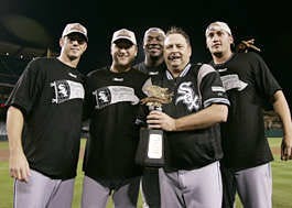 Chicago pitchers (from left) Jon Garland, Mark Buehrle, Jose Contreras, and Freddy Garcia celebrate with pitching coach Don Cooper (holding the American League Champiosnhip trophy) after the White Sox beat the Los Angeles Angels, 6-3, in Game 5 Sunday night. All four pitchers pitched complete games as the White Sox won the series, 4-1. Kevork Djansezian | Associated Press