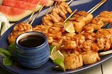 Grilled Scallops and Shrimp with Ginger-Limeade Pad Thai Marinade, an easy but brightly seasoned addition to grilling or broiling choices. The marinade becomes the dipping sauce served with cooked dish. AP photo