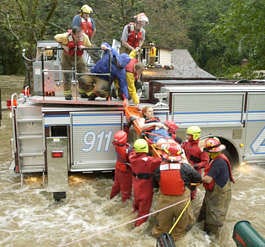 Firefighters from Earl Township and the Boyertown Friendship Fire Company rescue a woman who had been trapped in floodwaters from Manatawny Creek, Saturday, Oct. 8, 2005, near Boyertown, Pa. (AP Photo/The (Pottstown) Mercury, John Strickler)
