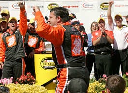 Tony Stewart celebrates after winning the Dodge/Save Mart 350 Nextel Cup race at Infineon Raceway in Sonoma, Calif., Sunday. Jeff Chiu | Associated Press