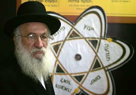 Rabbi Levi Yitzchak Halperin works at the the Institute for Science and Halacha Wednesday in Jerusalem. The placard in the background reads in Hebrew: consultation, awareness, implementation, developing, publishing. Baz Ratner | Associated Press