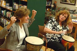 Kathy Hall, left, cheers to the music as Dawnelle Neighbors drums along during a drumming class last month at St. Mary\'s Hope Cancer Resource Center. The class, which is held weekly, is used for relaxation and stress relief. Vincent Pugliese | Associated Press