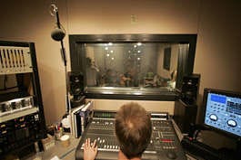 The band Idlewild performs, center through window, in the studio at KEXP on Sept. 30. Kevin P. Casey | Associated Press