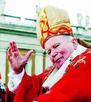 Pope John Paul II delivers his blessing as he arrives St. Peter\'s Square at the Vatican for the Vespers celebrations, Saturday, May 29, 2004. (AP file Photo/Plinio Lepri)