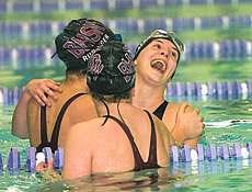 North\'s Katy Sandberg laughs as she celebrates winning the 500-yard freestyle event with teammates Amy Rubinger (left) and Elizabeth Munroe during Saturday\'s sectional at South. Staff photo by David Snodgress