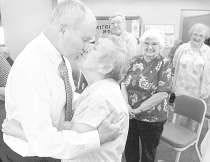 Indiana Gov. Joe Kernan is embraced and kissed by Beluah Krlin as he arrives at Jenks Rest senior center Thursday in Lafayette. Kernan came to the center to speak about Hoosier Rx, Indiana\'s prescription drug plan for low-income senior citizens. AP Photo.