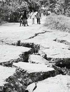 A badly damaged road is seen Tuesday, a day after an earthquake struck the Indonesian island of Nias. The 8.7-magnitude quake hammered Indonesia\'s west coast, sparking panic across Indian Ocean countries still traumatized by the tsunami disaster three months ago. AP photo