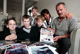 Walt Mezich, right, talks about his experience crabbing Thursday as he and his wife, Jennifer, sit in their Anchorage, Alaska, home with their sons, from left, Max, 11, Ryan, 13, Andrew, 15, and Spencer, 7. The 58-year-old, who was a Bering Sea crab boat skipper for 30 years, now finds himself unemployed because of a new crab rationalization plan that replaces derby-style crabbing, allowing boat owners to send out fewer vessels. Al Grillo | Associated Press
