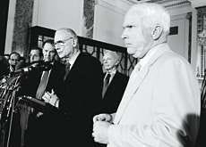 Sept. 11 commission vice chairman and former Indiana Rep. Lee Hamilton, center, speaks at a news conference on Capitol Hill Thursday following the release of the commission\'s final report. Behind Hamilton are commission chairman Thomas Kean, left, and Sen. Joseph Leiberman, D-Conn, second right. At right is Sen. John McCain, R-Ariz. AP Photo.