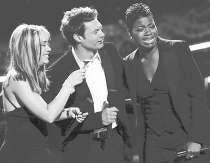 Runner-up Diana DeGarmo, left, looks at the envelope as host Ryan Seacrest talks to winner Fantasia Barrino, right, at the end of the "American Idol" live finale, Wednesday in Los Angeles. AP Photo.