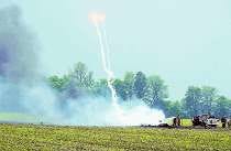 Flares explode as fire consumes the wreckage of one of two F-16s involved in a collision near Oaktown Monday. Two F-16 fighter jets collided in midair Monday over southwestern Indiana, killing one of the pilots, the Indiana Air National Guard said. The other pilot parachuted to safety. AP Photo.